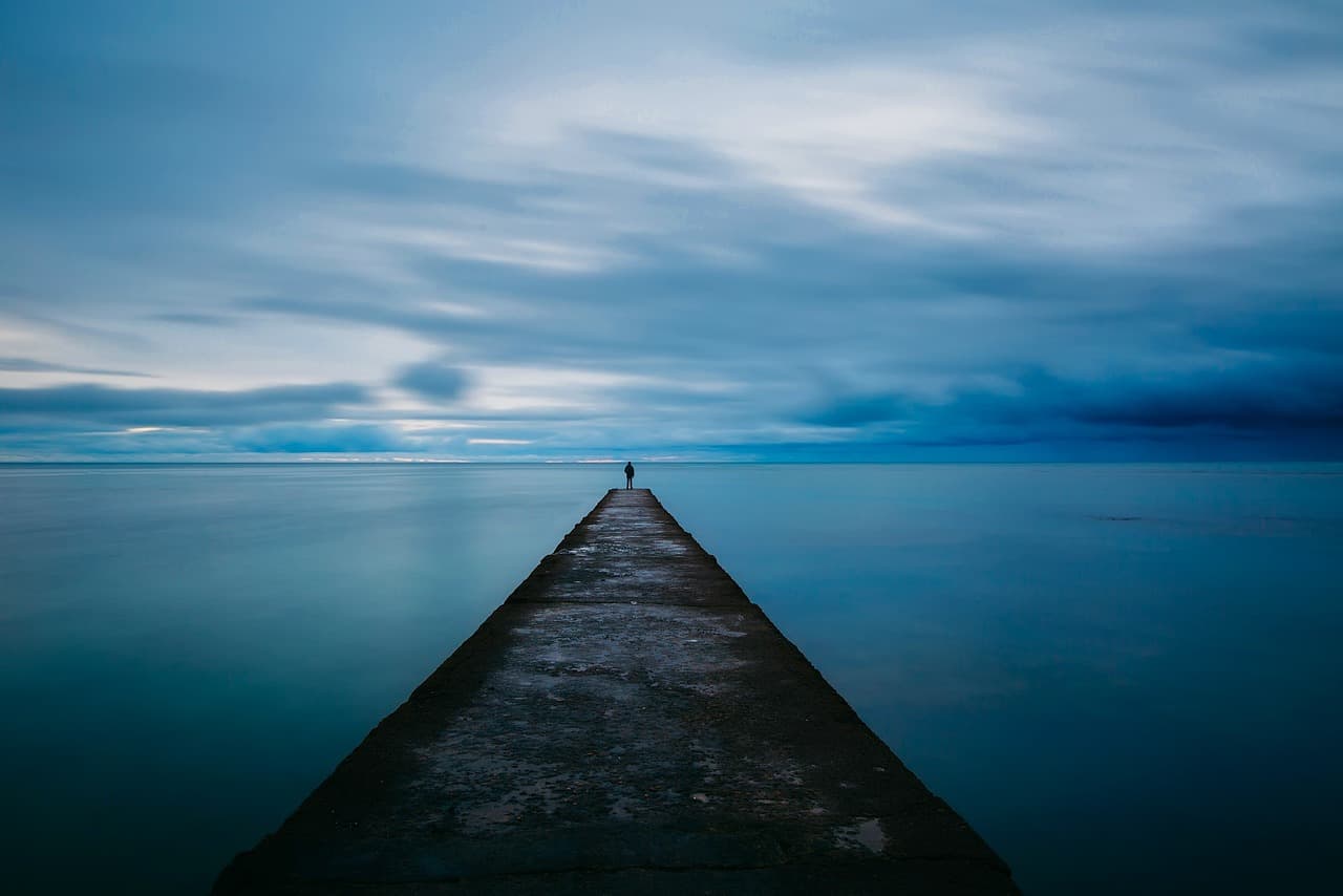 dock, pier, dusk, sky, clouds, sea, ocean, water, jetty, nature, person, alone, silhouette, outdoors, seaside, blue sky, blue water, seascape, solitary, solitude [pid:1979547][dark]